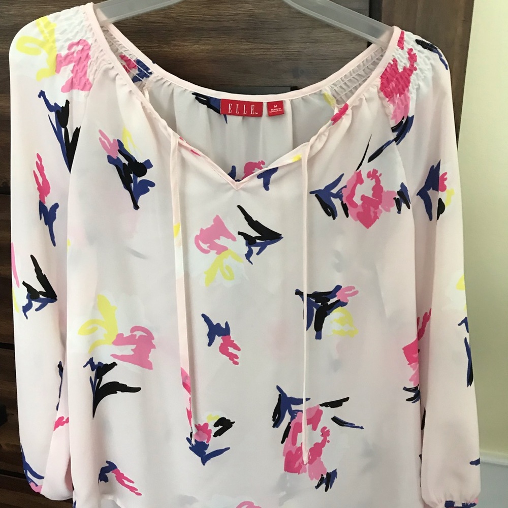 Sheer, light pink blouse.